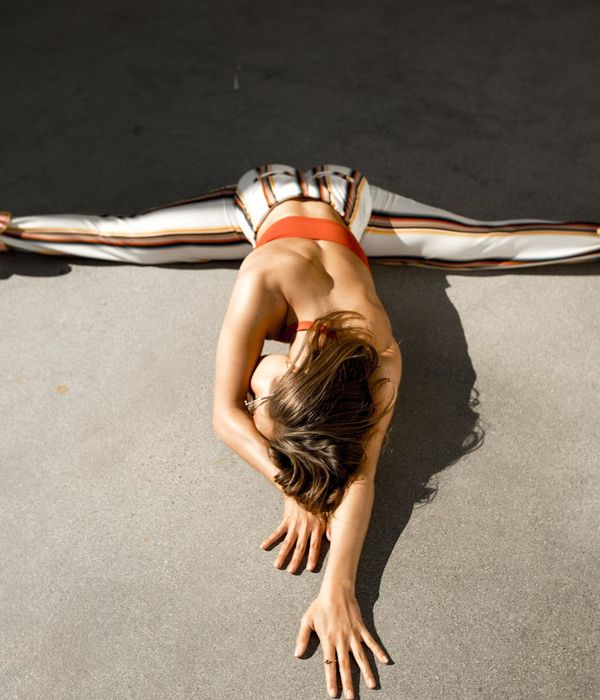 Woman in a calm yoga pose on a light background symbolizing inner peace.